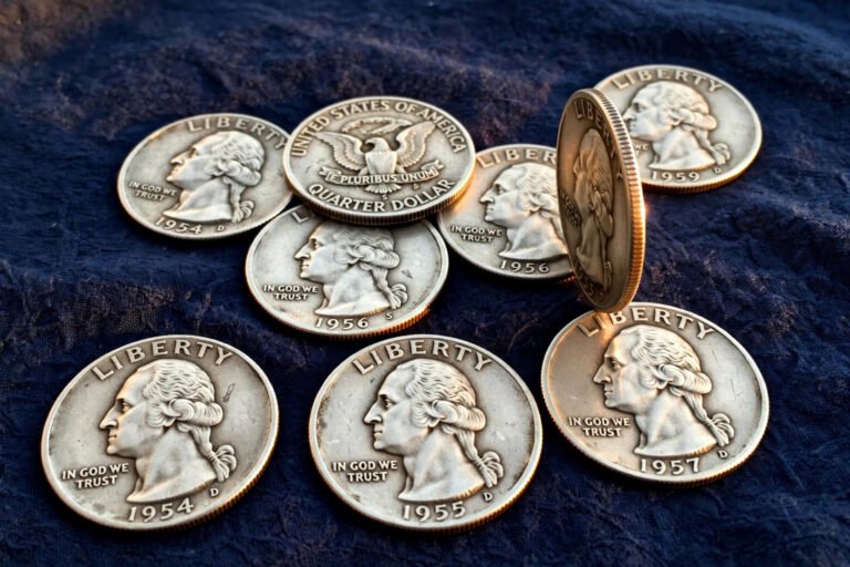 Vintage silver Washington quarters on navy cloth